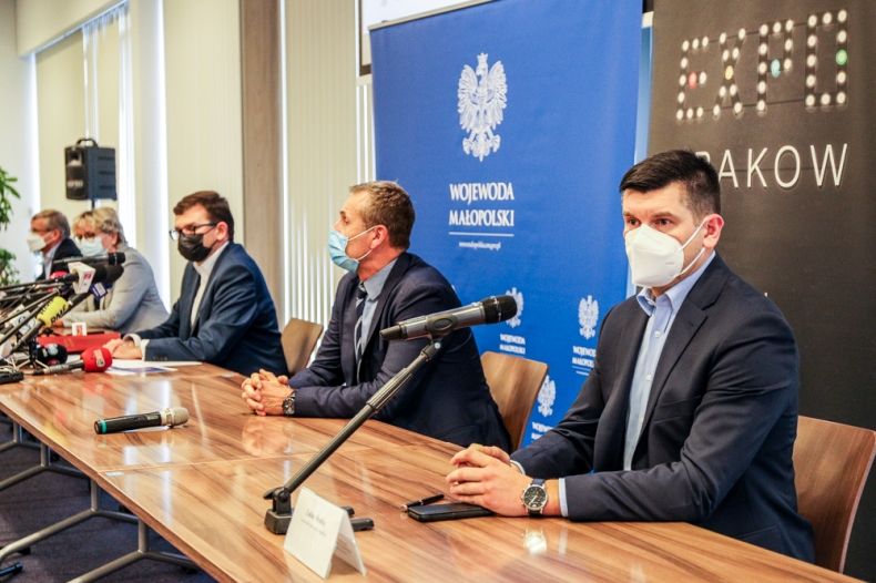 Zdjęcie przedstawia konferencję prasową: pięć osób siedzących przy stole konferencyjnym