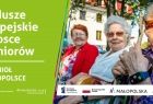 Plakat kampanii: napis Fundusze Europejskie w trosce o seniorów. Tele-Anioł w Małopolsce oraz zdjęcie starszych kobiet siedzących na ławce na zewnątrz, jedna z nich z opaską na ręce