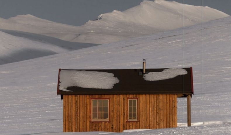 Zdjęcie zaśnieżonych gór a u ich stóp mały drewniany domek
