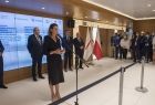 Konferencja prasowa na temat Igrzysk Europejskich 2023. Przemawia minister sportu Danuta Dmowska-Andrzejuk. Za minister stoją uczestnicy konferencji. W tle duży ekran z logo imprezy 