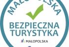 Okrągłe logo z napisem Małopolska Bezpieczna Turystyka