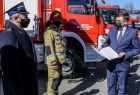 Wojewoda Łukasz Kmita wręcza akt przekazania samochodu gaśniczego przedstawicielowi straży pożarnej
