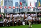 Góralska Orkiestra Dęta w czasie koncertu w Chinach, w tle widoczne napisy w języku chińskim i nowoczesne wieżowce.