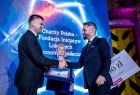 Wicemarszałek Łukasz Smółka ściska dłoń laureatowi.