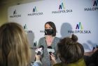 Marta Malec-Lech z zarządu województwa podczas konferencji prasowej. W tle widoczna ścianka z napisem Małopolska.