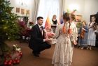 wicemarszałek Łukasz Smółka i dwie małe kolędniczki
