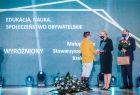 Iwona Gibas i Jan Tadeusz Duda wręczają nagrodę na scenie