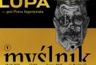 Złoto czarna grafika. U góry i na dole napisy. Górna część w kolorze czarnym i złote napisy. Dolna część w kolorze złotym i czarne napisy. W środku grafika męskiej głowy 