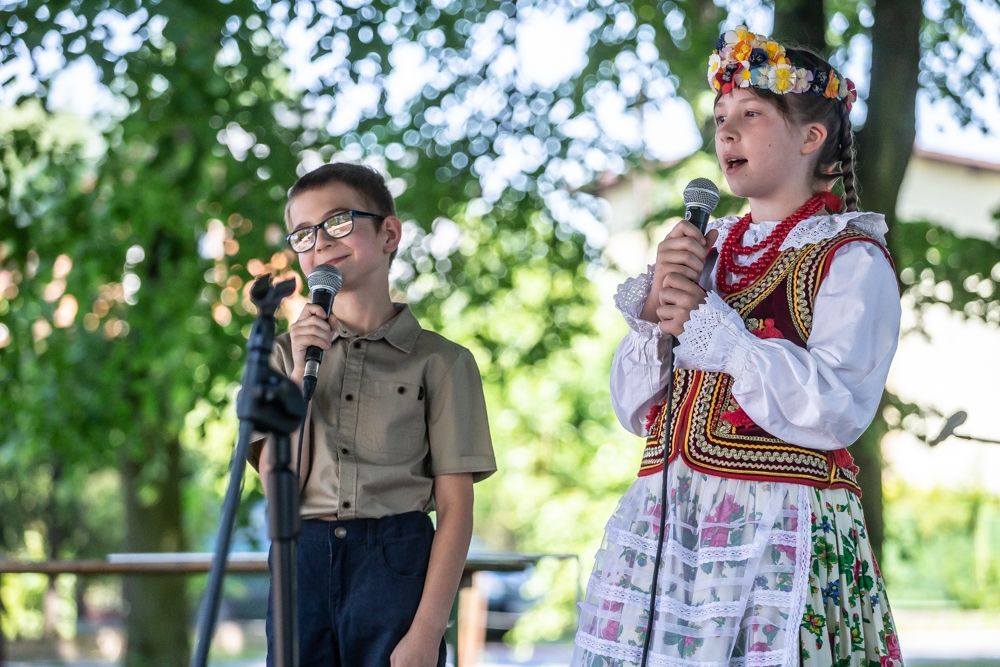 Chłopiec i dziewczynka w stroju ludowym podczas występu