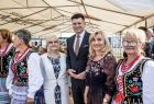 Wicemarszałek Łukasz Smółka stoi z kobietami pod namiotem.