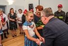 Marszałek Witold Kozłowski rozmawiający z jedną z dziewczynek z zespołu regionalnego