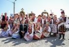 pozujący do zdjęcia z zespołem regionalnym w strojach ludowych Marszałek Łukasz Smółka
