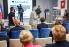 Marszałek Witold Kozłowski przemawia na scenie. Na pierwszym planie siedzą beneficjenci.