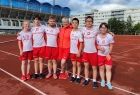 Pamiątkowe zdjęcie polskich sportowców stojących na bieżni w rzędzie wraz z trenerem