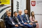 Ludzie siedzący na widowni. Z tyłu widoczny baner z napisem Wojewódzka Rada Bezpieczeństwa Ruchu Drogowego.