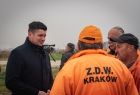Wicemarszałek Łukasz Smółka rozmawia z pracownikami z napisem ZDW Kraków.