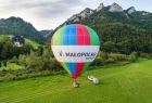 Balon z napisem "Małopolska" na tle zieleni i gór