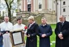  Dziedziniec zakonu Paulinów na krakowskiej Skałce, w tle widać mury zakonne. Na pierwszym planie, marszałek Witold kozłowski, prof. Jan Tadeusz Duda i wicemarszałek Iwona Gibas, przekazują zakonnika, pamiątkowy list intencyjny. 