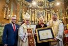 Iwona Gibas z proboszczem parafii pw. Świętego Marcina Bpa w Jawiszowicach prezentują złoty medal Polonia Minor