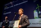 Jeden z laureatów mówi do mikrofonu, stojąc na scenie