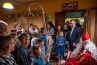 Święty Mikołaj oraz Marszałek Województwa Małopolskiego Witold Kozłowski wita się z dziećmi i ich opiekunami w rodzinnym domu dziecka.