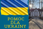 Baner z napisem Pomoc dla Ukrainy i flagą ukraińską. Po prawej widoczny zabytkowy budynek szpitala.