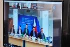 Widok na monitor w sali konferencyjnej na którym są widoczni uczestnicy spotkania.