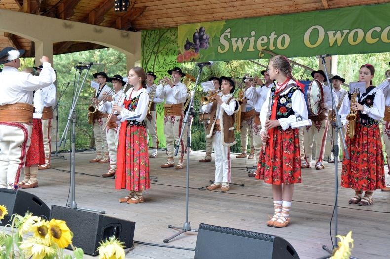 Na scenie dziecięca orkiestra w strojach ludowych.