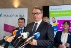 Radny Piotr Dziurdzia przemawia do mikrofonów.