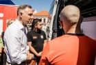 Prezydent Andrzej Duda rozmawia z ratownikami przy karetce.