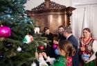 Tradycyjne ubieranie choinki. Na zdjęciach muzycy podczas śpiewu, gry na instrumentach i ubierania choinki. Są w strojach góralskich. 