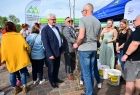 Wicemarszałek Józef Gawron wręcza drzewko mężczyźnie w szarym podkoszulku.