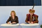 Dyrektorka szkoły podpisuje umowę z przedstawicielem Bractwa Kurkowego.