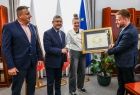 Wicemarszałek Witold Kozłowski oraz radny Mirosław Dróżdż przekazują nagrodę Polonia Minor.