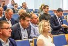 Widownia na sali. W ławach siedzą ludzie.