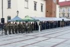 Namioty stoją na rynku, pod nimi stoją ludzie.