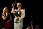 Iwona Gibas z zarządu województwa ze statuetką i bukietem kwiatów, który przekazała w podziękowaniu za wsparcie prezes klubu Millenium 