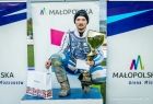 Sportowiec trzyma złoty puchar na podium.