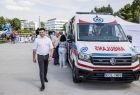 Wicemarszałek Łukasz Smółka obok ambulansu. 