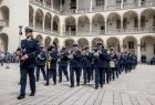 Orkiestra policyjna podczas przemarszu na dziedzińcu arkadowym Zamku Królewskiego na Wawelu.