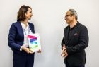 Członek zarządu Marta Malec-Lech wręcza teczkę mężczyźnie.