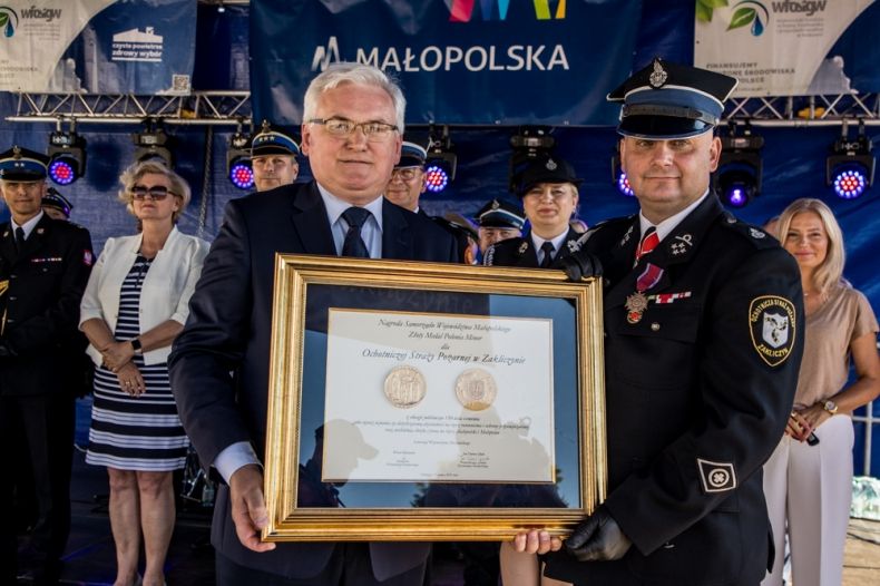 Wicemarszałek Józef Gawron i strażak trzymający medal Polonia Minor. 