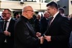 Marszałek Łukasz Smółka dzielący się opłatkiem z uczestnikami uroczystości