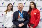 Wicemarszałek Witold Kozłowski z medalami na szyi. Obok dwie kobiety. 