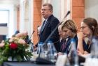 Wicemarszałek Witold Kozłowski przemawiający na stojąco przy stole.