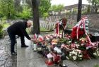 Wicemarszałek Ryszard Pagacz kładzie znicz na grobie.