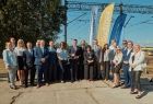 Uczestnicy wydarzenia stoją przy torach kolejowych.