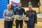 Iwona Gibas z zarządu województwa oraz burmistrz Trzebini przekazujący uroczyście strażakom ochotnikom nowo zakupione elementy strażackiego ekwipunku i wyposażenia