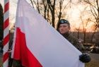 Żołnierze wciągają flagę Polski na maszt.
