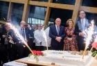 Wicemarszałek Ryszard Pagacz stoi z innymi ludźmi przy torcie.